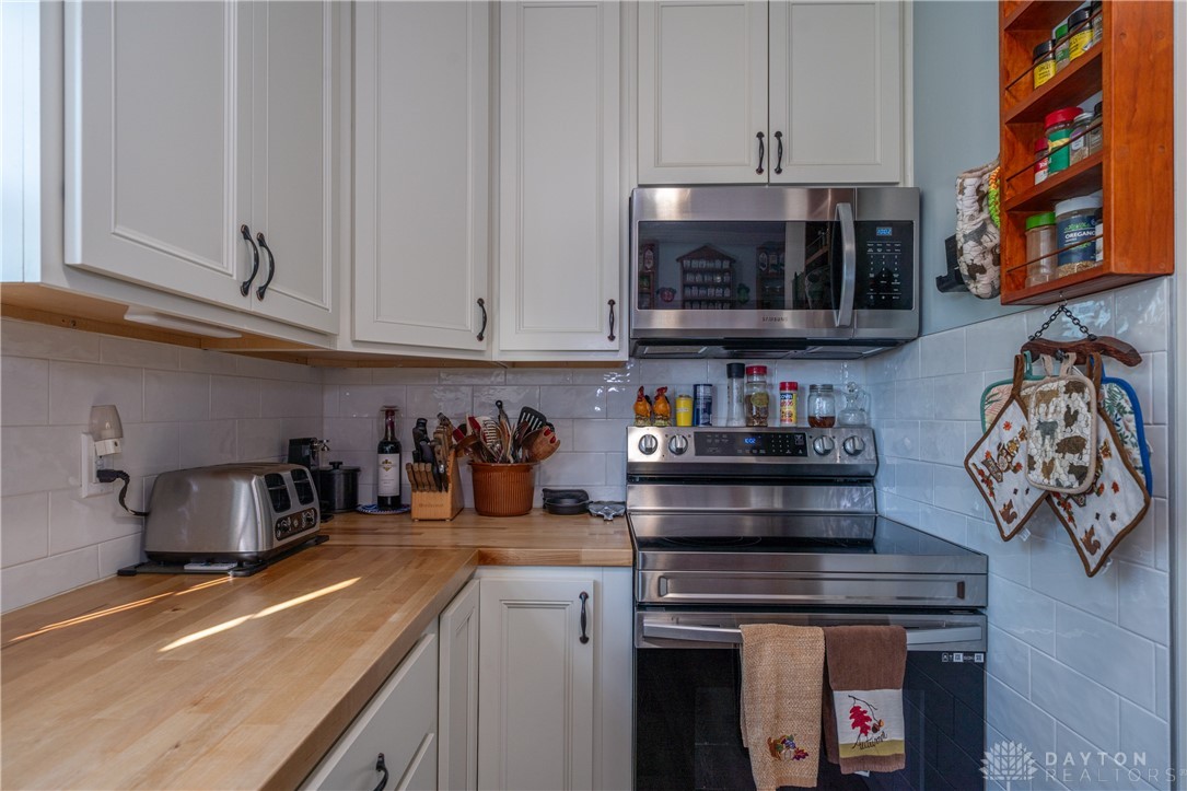 1599 Garringer Road Jamestown, OH 45335 - Photo 14 of 73 This bright kitchen features wood countertops, modern appliances, and convenient cabinetry for culinary enthusiasts.