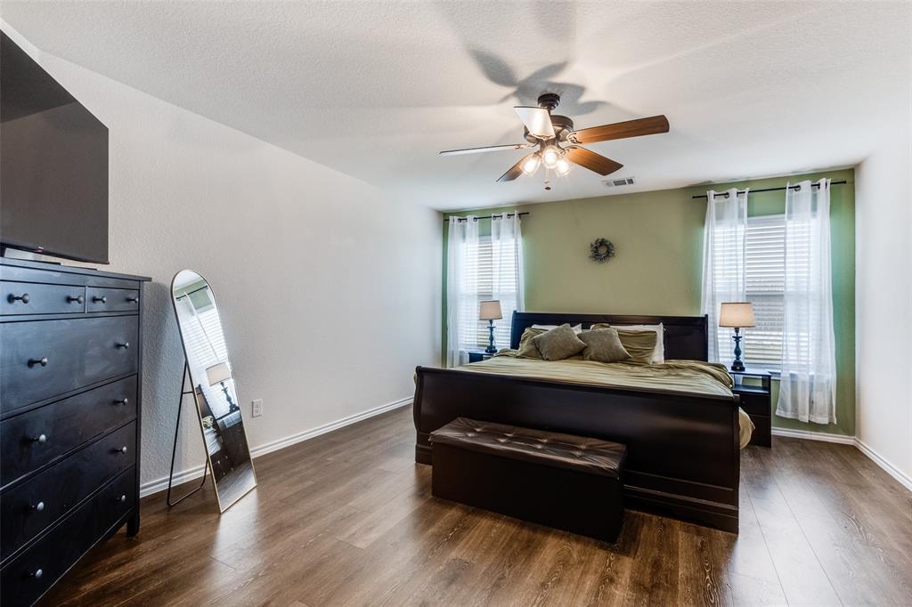 305 Ginger Avenue Anna, TX 75409 - Photo 12 of 28 a bed room with a bed and a chandelier