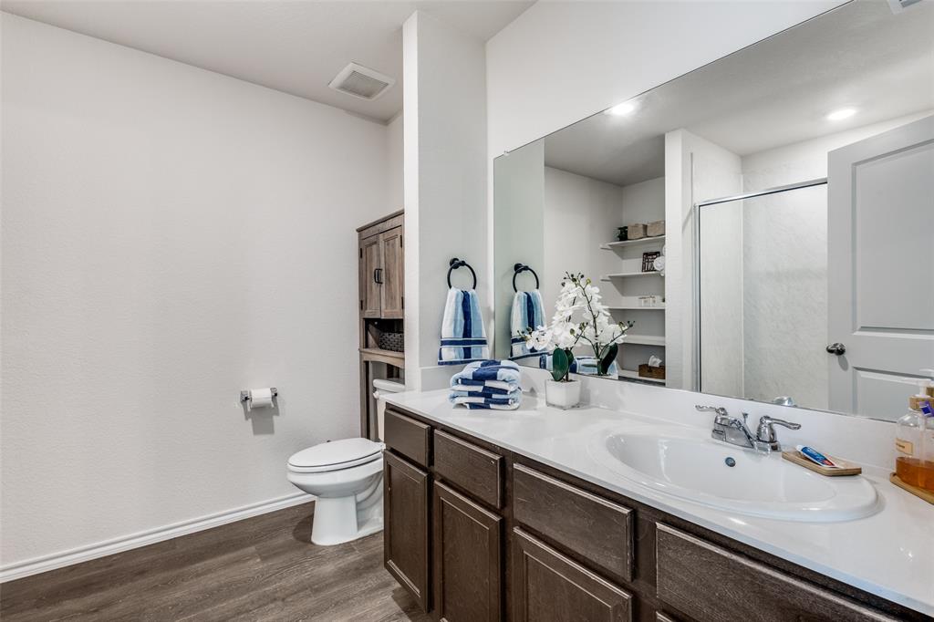 305 Ginger Avenue Anna, TX 75409 - Photo 14 of 28 a bathroom with a double vanity sink toilet and mirror