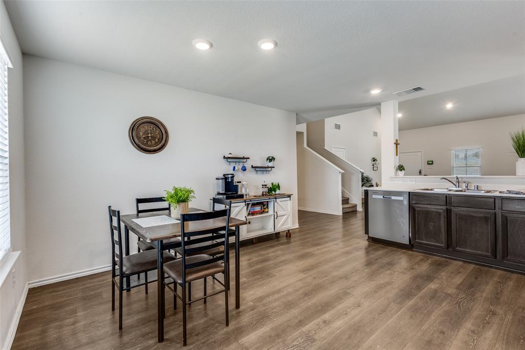 305 Ginger Avenue Anna, TX 75409 - Photo 10 of 28 a living room with kitchen island furniture wooden floor and clock on the wall