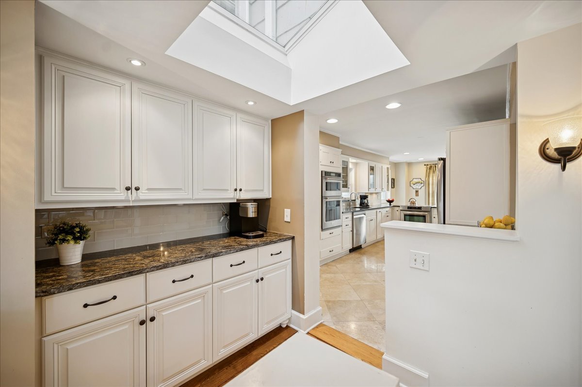 2085 Stirling Road Bannockburn, IL 60015 - Photo 11 of 48 a kitchen with granite countertop white cabinets and stainless steel appliances