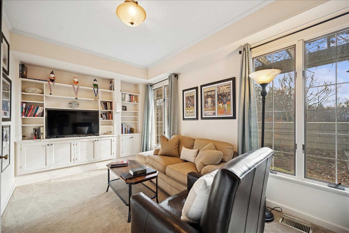 2085 Stirling Road Bannockburn, IL 60015 - Photo 22 of 48 a living room with furniture and a flat screen tv