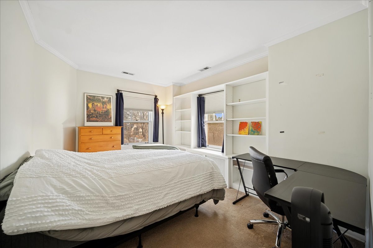 2085 Stirling Road Bannockburn, IL 60015 - Photo 26 of 48 a bedroom with a bed window and table chair