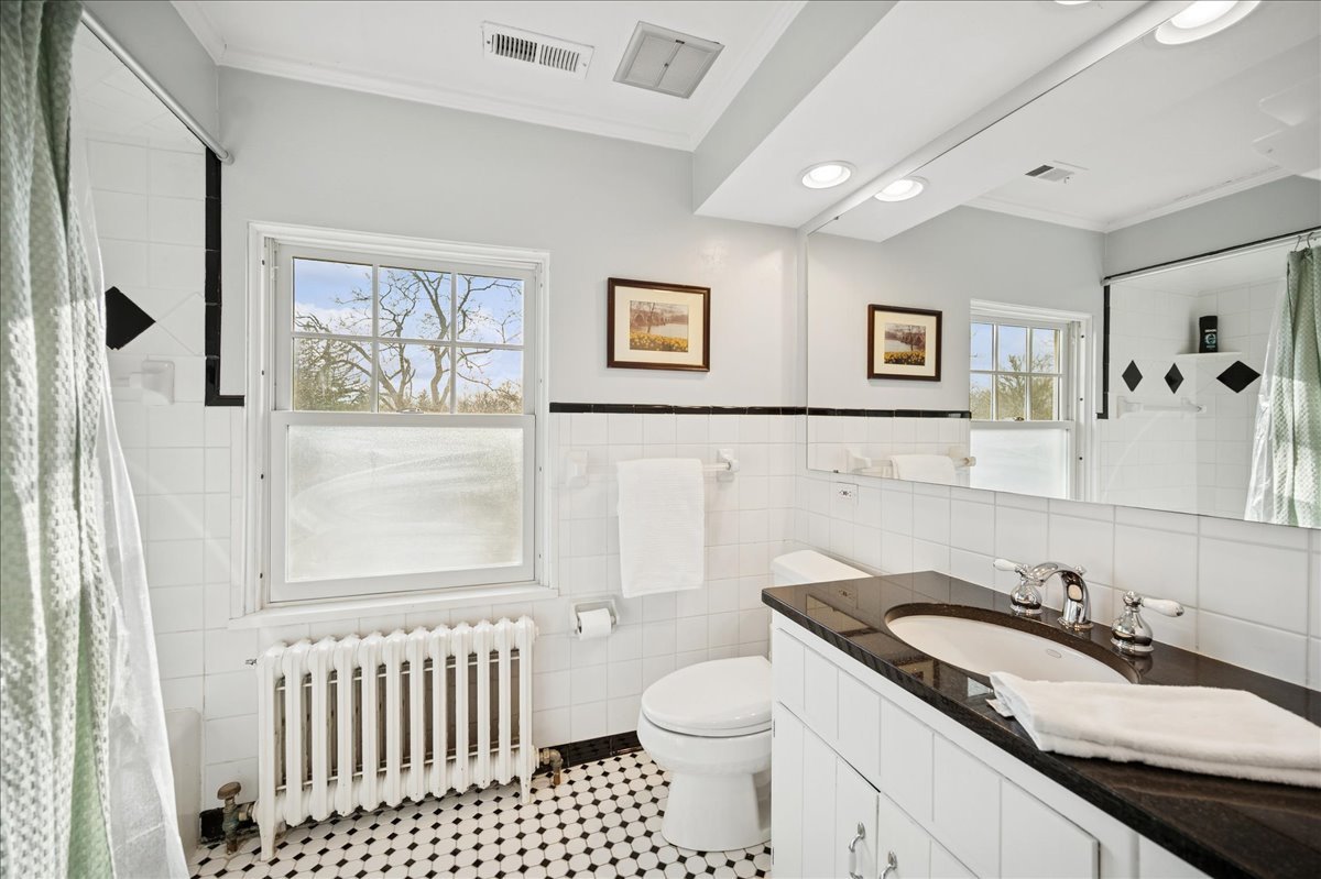 2085 Stirling Road Bannockburn, IL 60015 - Photo 28 of 48 a bathroom with a granite countertop sink and a toilet