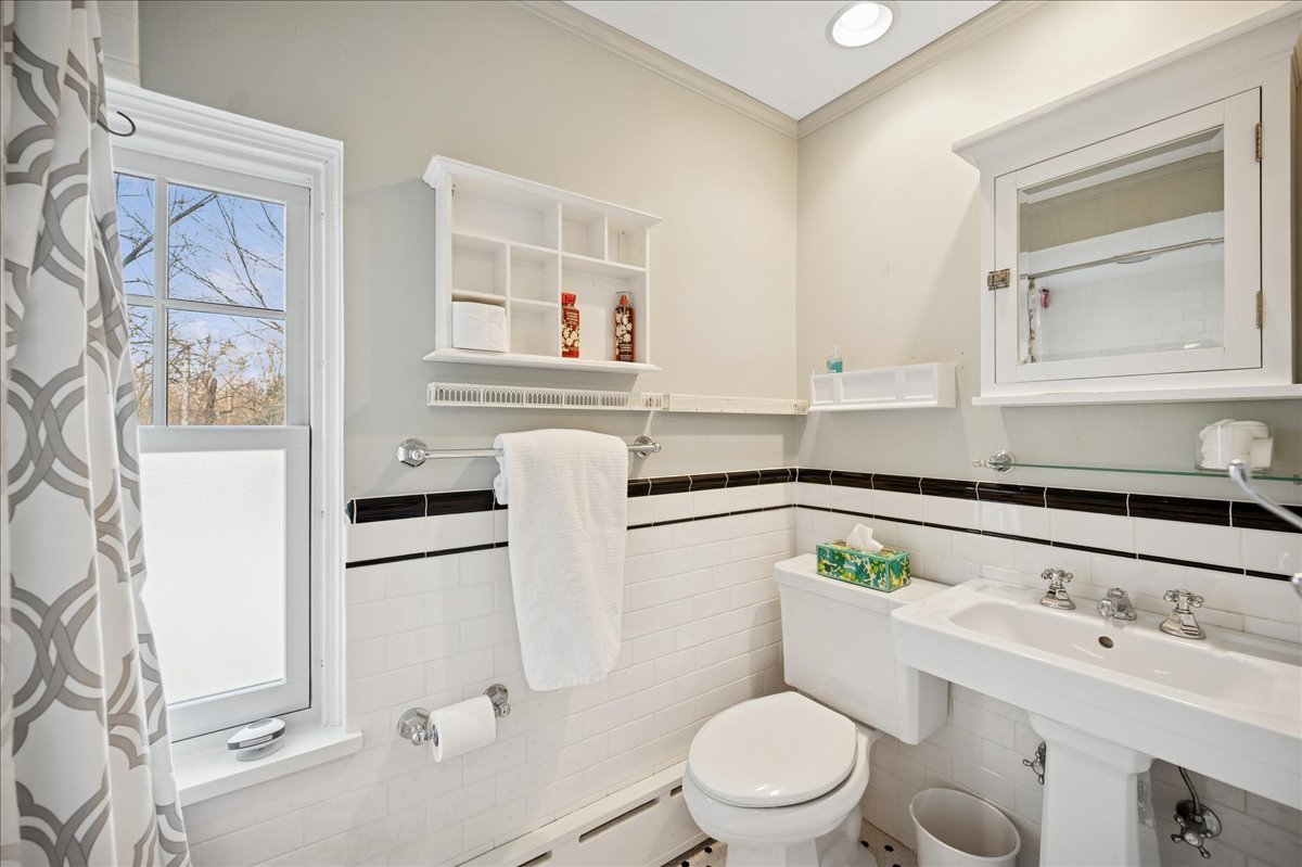 2085 Stirling Road Bannockburn, IL 60015 - Photo 31 of 48 a bathroom with a sink toilet and mirror