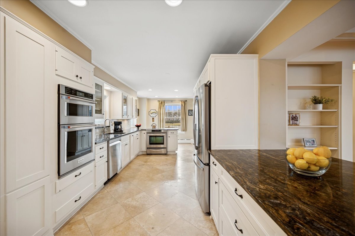 2085 Stirling Road Bannockburn, IL 60015 - Photo 8 of 48 a large kitchen with cabinets and stainless steel appliances
