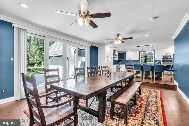 a large kitchen with kitchen island a large counter space a sink stainless steel appliances and cabinets