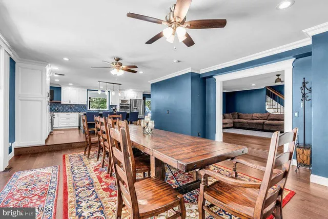 a kitchen with a dining table cabinets and refrigerator