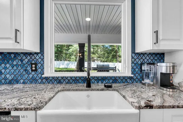 a stove top oven sitting inside of a kitchen