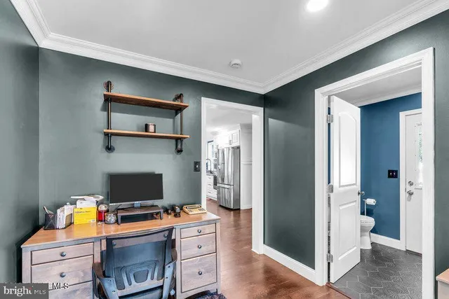 a spacious bedroom with a bed and a dresser