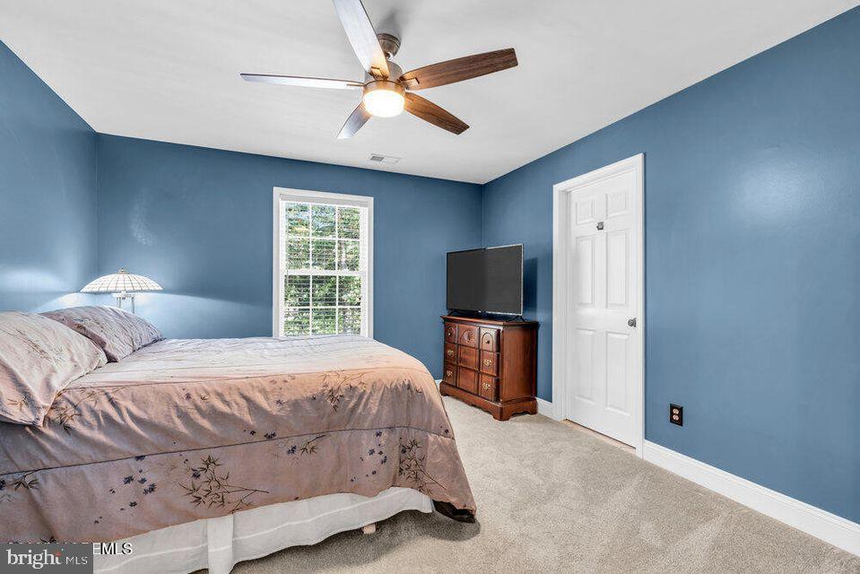 225 West Bird Village Road Jackson, NJ 08527 - Photo 38 of 66 a bedroom with a bed and a flat screen tv