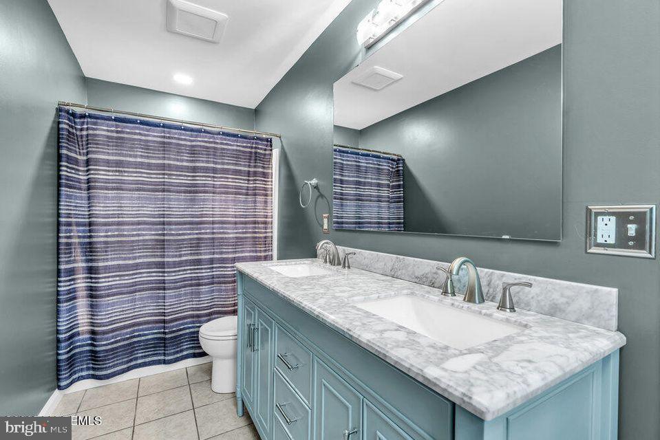 225 West Bird Village Road Jackson, NJ 08527 - Photo 43 of 66 a bathroom with a granite countertop sink a toilet and mirror