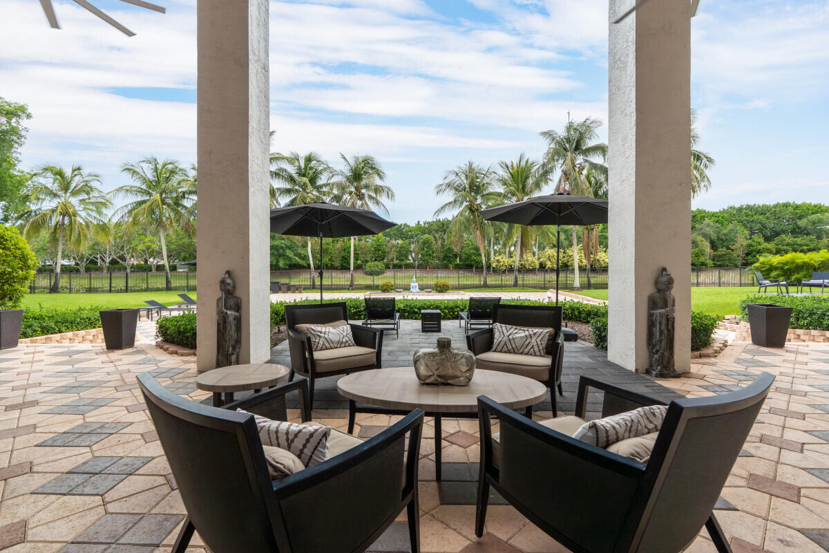 3500 Windmill Ranch Road Weston, FL 33331 - Photo 22 of 47 a view of a patio with couches potted plants and a big yard