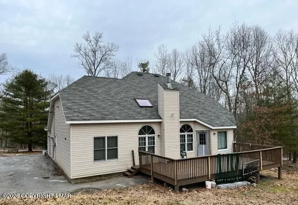 a view of a house with wooden fence