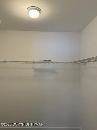 an empty room with window and closet