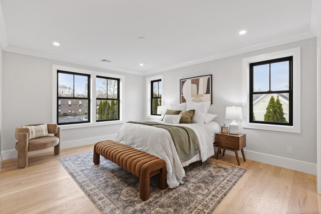 10 Webber Avenue, Unit 201 Bedford, MA 01730 - Photo 12 of 35 a spacious bedroom with a bed and a large window