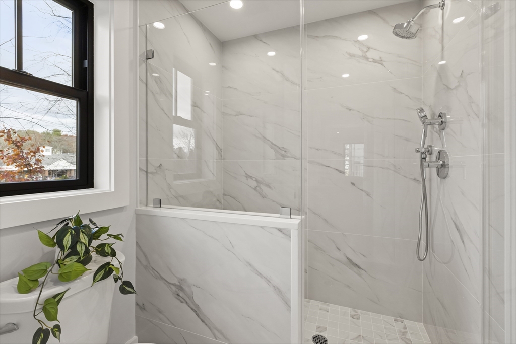 10 Webber Avenue, Unit 201 Bedford, MA 01730 - Photo 14 of 35 a bathroom with a bathtub and shower