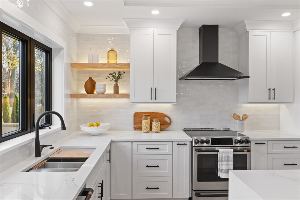 10 Webber Avenue, Unit 201 Bedford, MA 01730 - Photo 5 of 35 a kitchen with a stove a sink and a refrigerator