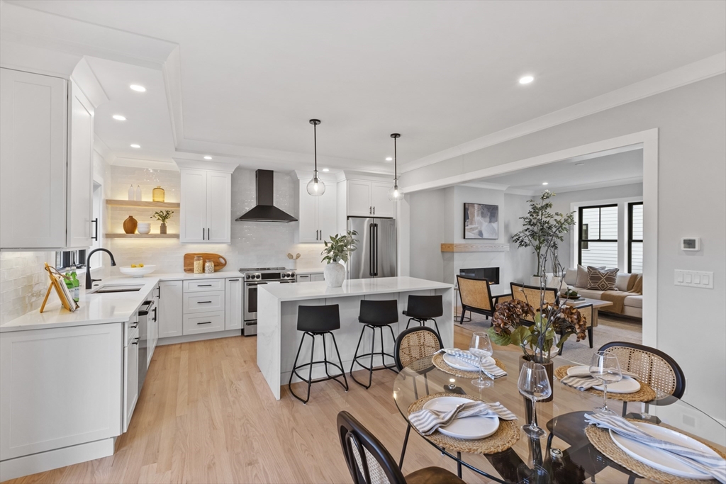 10 Webber Avenue, Unit 201 Bedford, MA 01730 - Photo 6 of 35 a large kitchen with a table and chairs