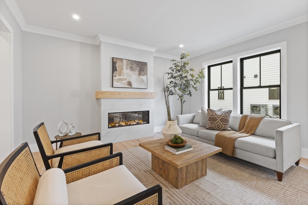 10 Webber Avenue, Unit 201 Bedford, MA 01730 - Photo 8 of 35 a living room with furniture and a fireplace