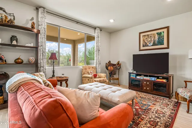 a bedroom with two beds and a flat screen tv