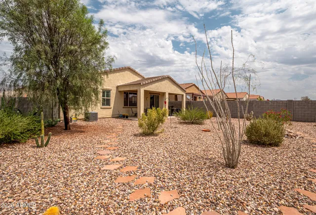 a view of a house with a yard covered in snow