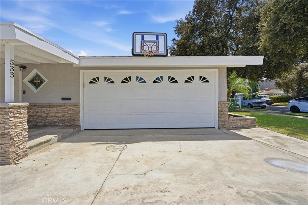 533 South Devon Road Orange, CA 92868 - Photo 9 of 50 a front view of a house with a yard and garage
