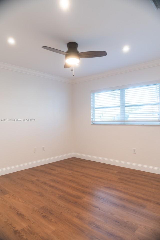 2224 Tinker Street Port Charlotte, FL 33948 - Photo 20 of 42 an empty room with wooden floor and windows