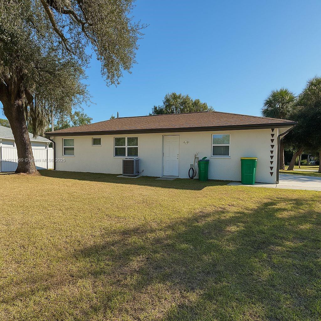 2224 Tinker Street Port Charlotte, FL 33948 - Photo 29 of 42 a view of a white house with a yard