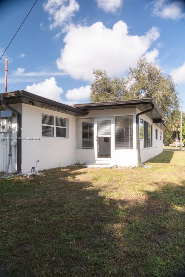 2224 Tinker Street Port Charlotte, FL 33948 - Photo 34 of 42 a backyard of a house with table and chairs