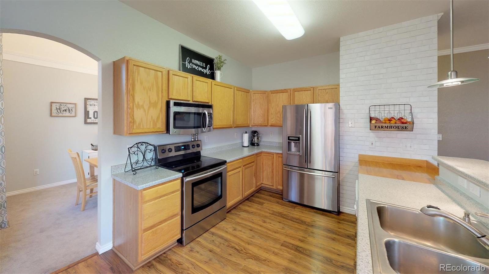 601 Rider Ridge Drive Longmont, CO 80504 - Photo 3 of 32 a kitchen with stainless steel appliances granite countertop a refrigerator stove top oven a sink and dishwasher