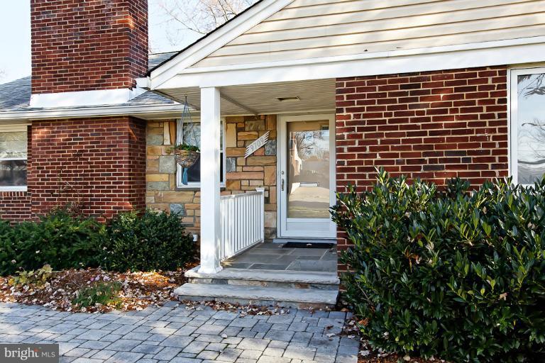 9709 Saxony Road Silver Spring, MD 20910 - Photo 2 of 24 a front view of a house with a garden and plants