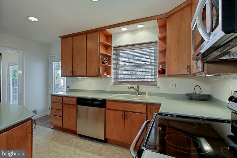 9709 Saxony Road Silver Spring, MD 20910 - Photo 11 of 24 a kitchen that has a sink and a stove