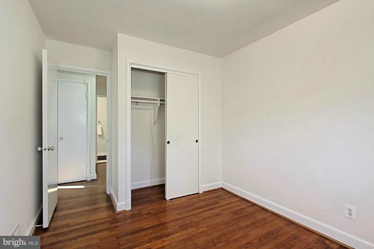 9709 Saxony Road Silver Spring, MD 20910 - Photo 14 of 24 a view of an empty room with wooden floor and a window