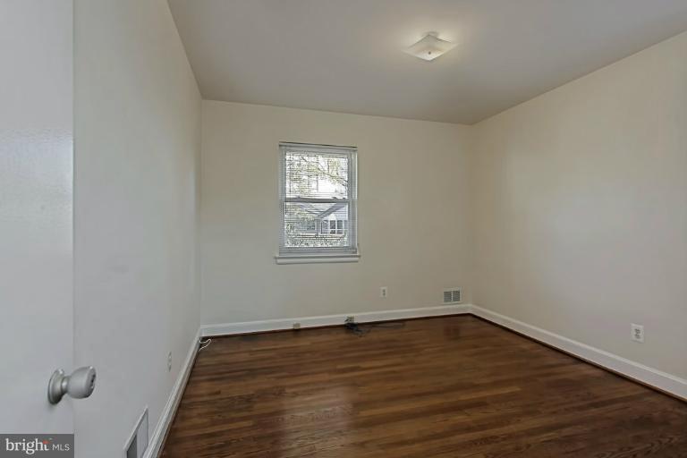9709 Saxony Road Silver Spring, MD 20910 - Photo 15 of 24 wooden floor in an empty room