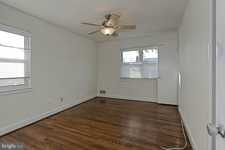 9709 Saxony Road Silver Spring, MD 20910 - Photo 16 of 24 a view of an empty room with wooden floor and a window