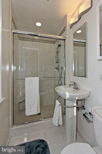 9709 Saxony Road Silver Spring, MD 20910 - Photo 21 of 24 a bathroom with a sink toilet and shower