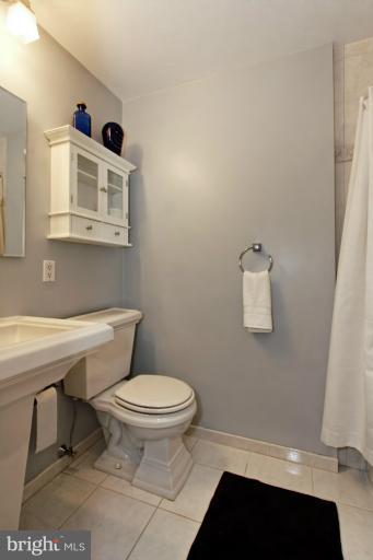 9709 Saxony Road Silver Spring, MD 20910 - Photo 22 of 24 a bathroom with a sink toilet and shower