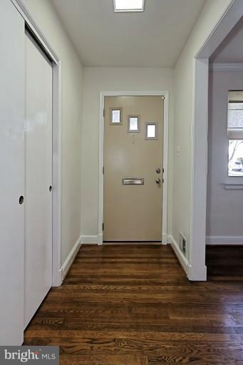 9709 Saxony Road Silver Spring, MD 20910 - Photo 4 of 24 a view of an empty room with wooden floor and a bathroom