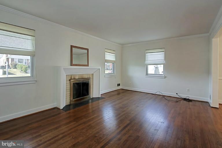 9709 Saxony Road Silver Spring, MD 20910 - Photo 5 of 24 a view of an empty room with wooden floor and a window