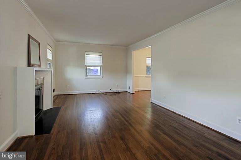 9709 Saxony Road Silver Spring, MD 20910 - Photo 6 of 24 an empty room with wooden floor and windows