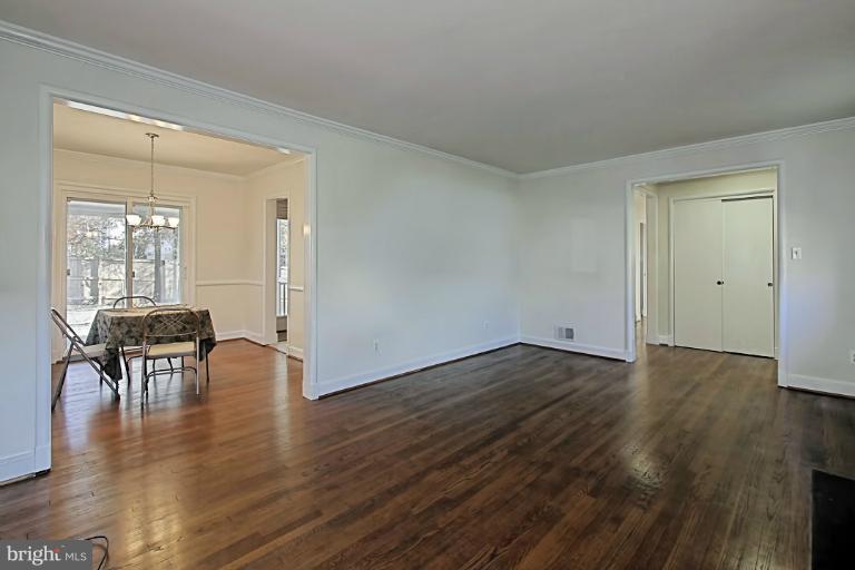 9709 Saxony Road Silver Spring, MD 20910 - Photo 7 of 24 an empty room with wooden floor and windows