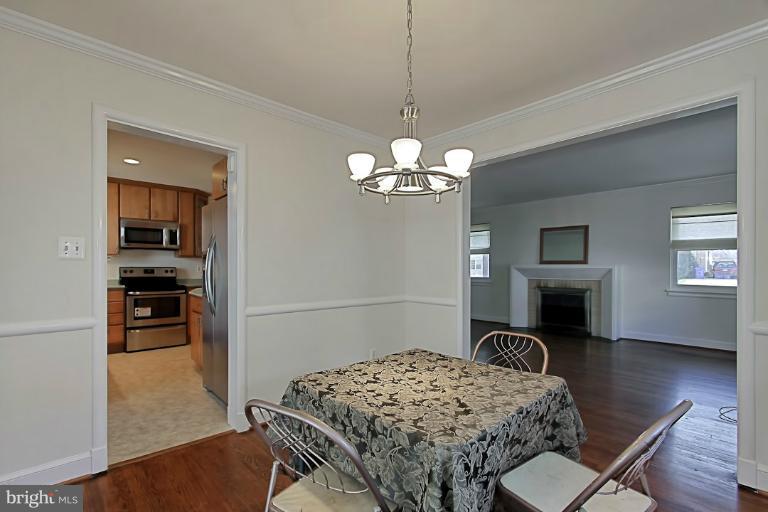 9709 Saxony Road Silver Spring, MD 20910 - Photo 9 of 24 a bedroom with furniture and a chandelier