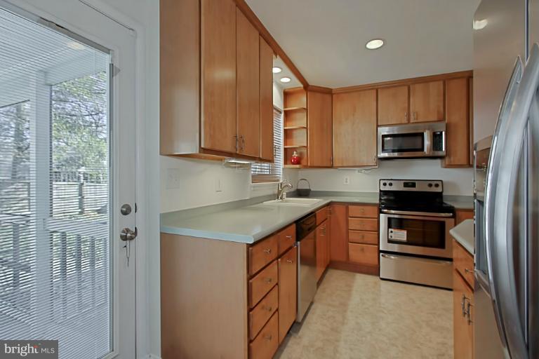 9709 Saxony Road Silver Spring, MD 20910 - Photo 10 of 24 a kitchen with stainless steel appliances granite countertop a stove a sink and a microwave