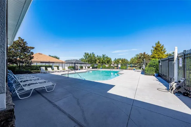 a view of a swimming pool with a lounge chair