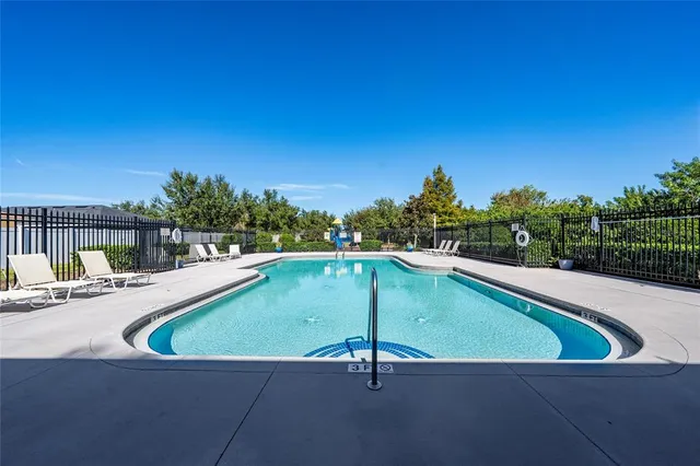 a view of a house with a yard and palm trees