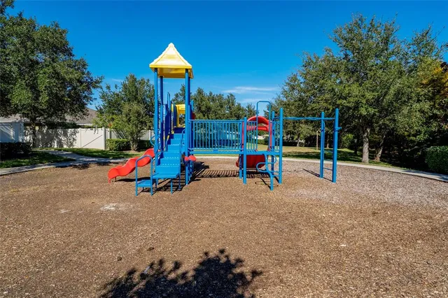 a view of a park with slide and a fountain