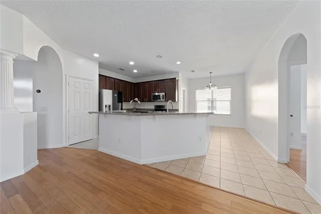 a kitchen with stainless steel appliances granite countertop a stove microwave and cabinets