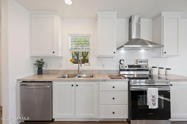 a kitchen with stainless steel appliances a sink stove and cabinets