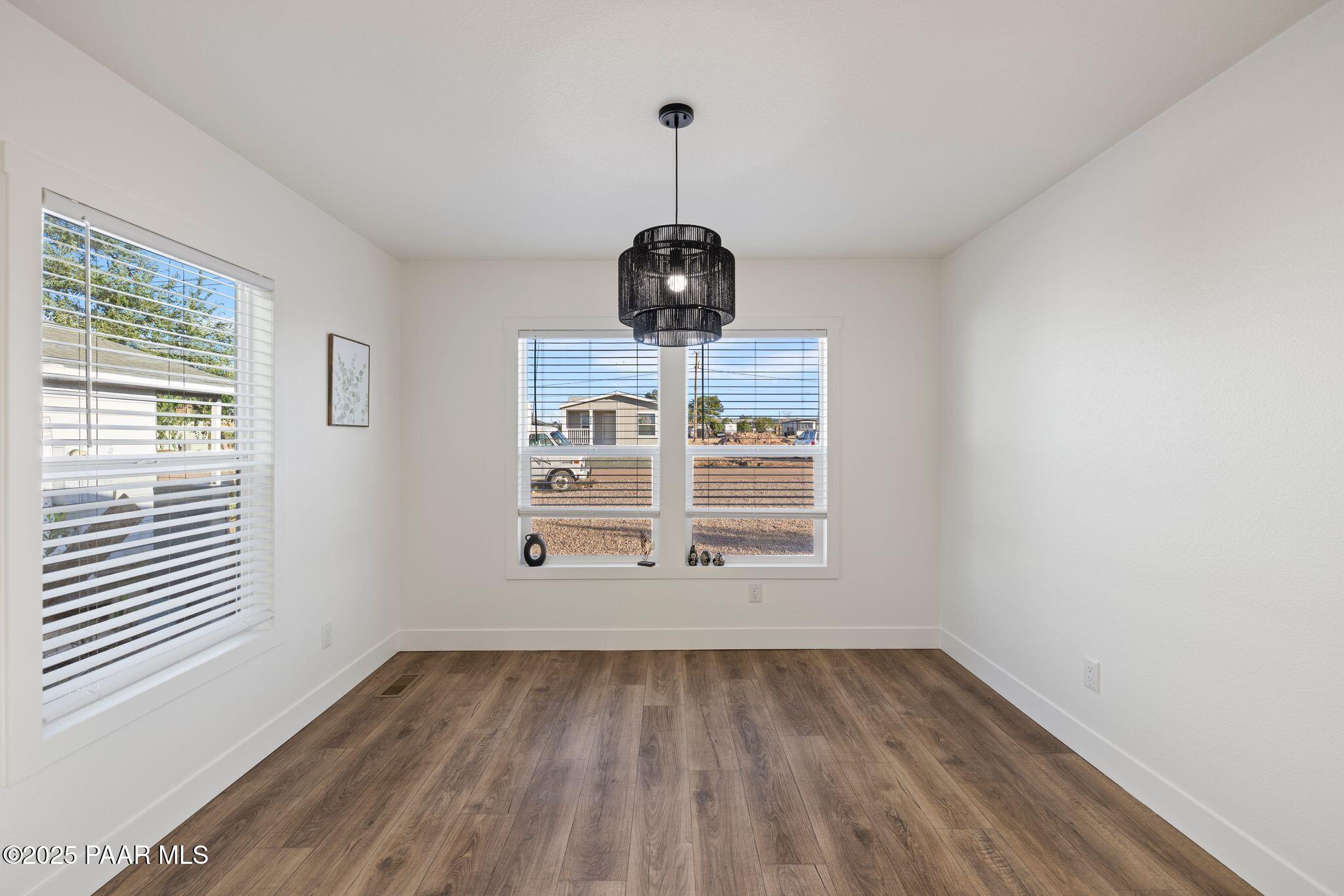 375 West Venice Way Paulden, AZ 86334 - Photo 16 of 41 a view of empty room with wooden floor and fan